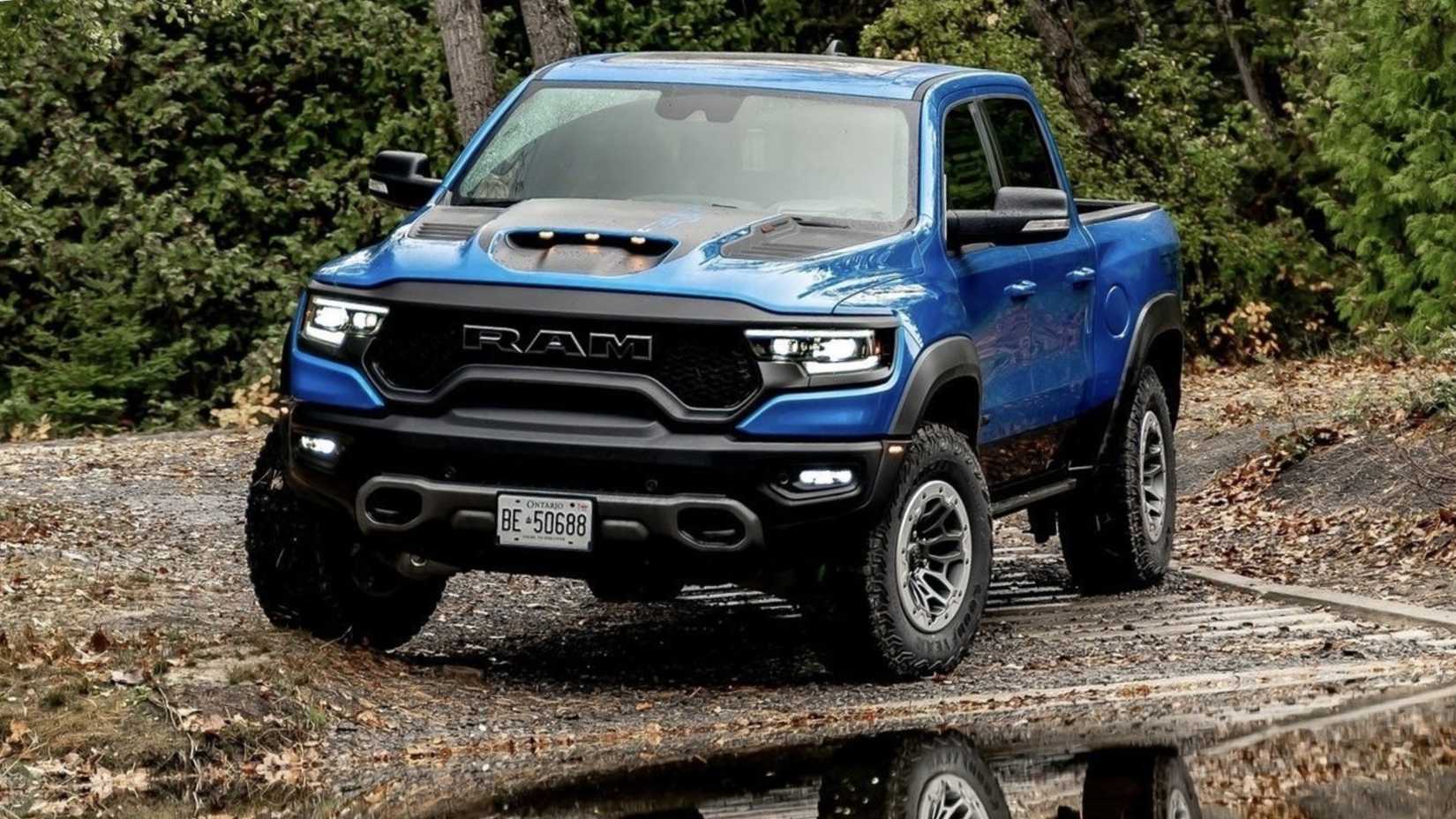 2021 RAM 1500 TRX in blue posing in woodland in front of lake