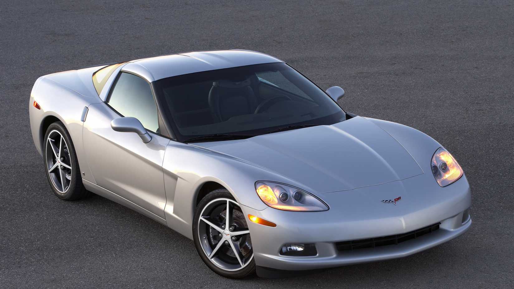 2012 Chevrolet Corvette Coupe in silver posing on asphalt