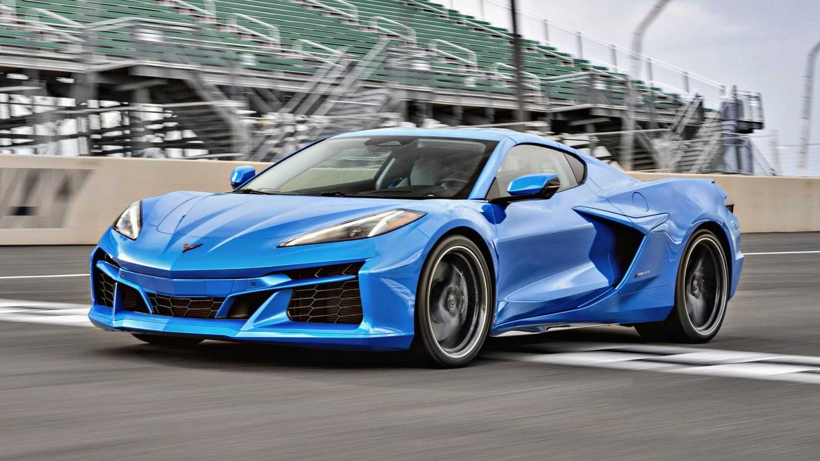 Blue 2024 Chevrolet Corvette E-Ray driving on a track