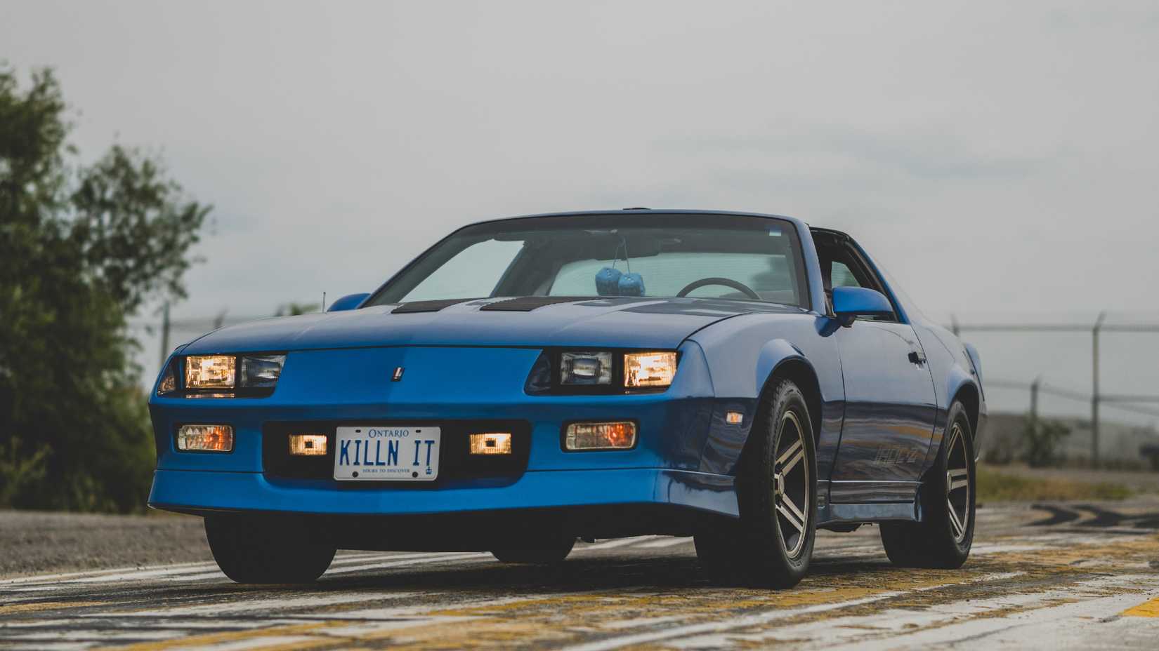 Three quarter shot of parked blue Chevy Camaro IROC-Z