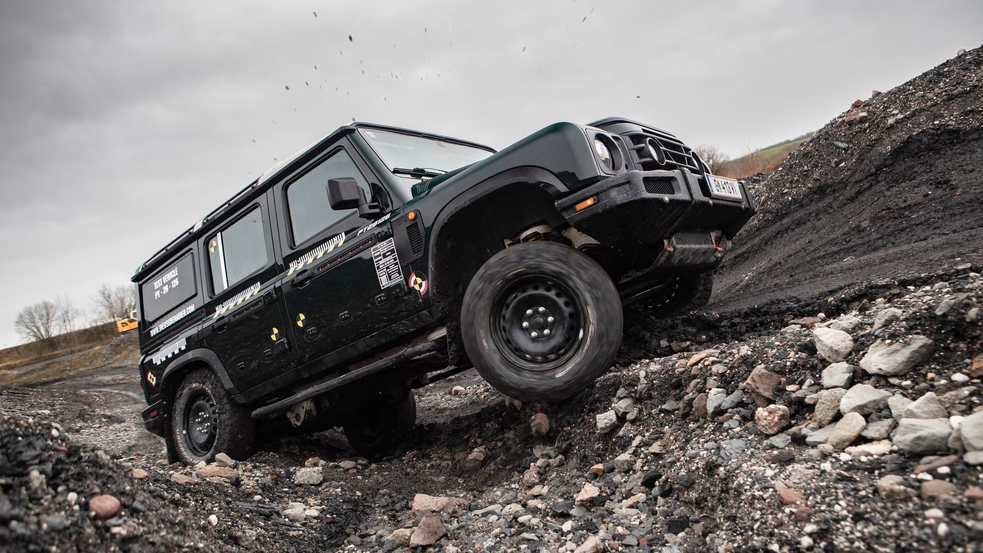 Ineos Grenadier in black traversing rocky terrain