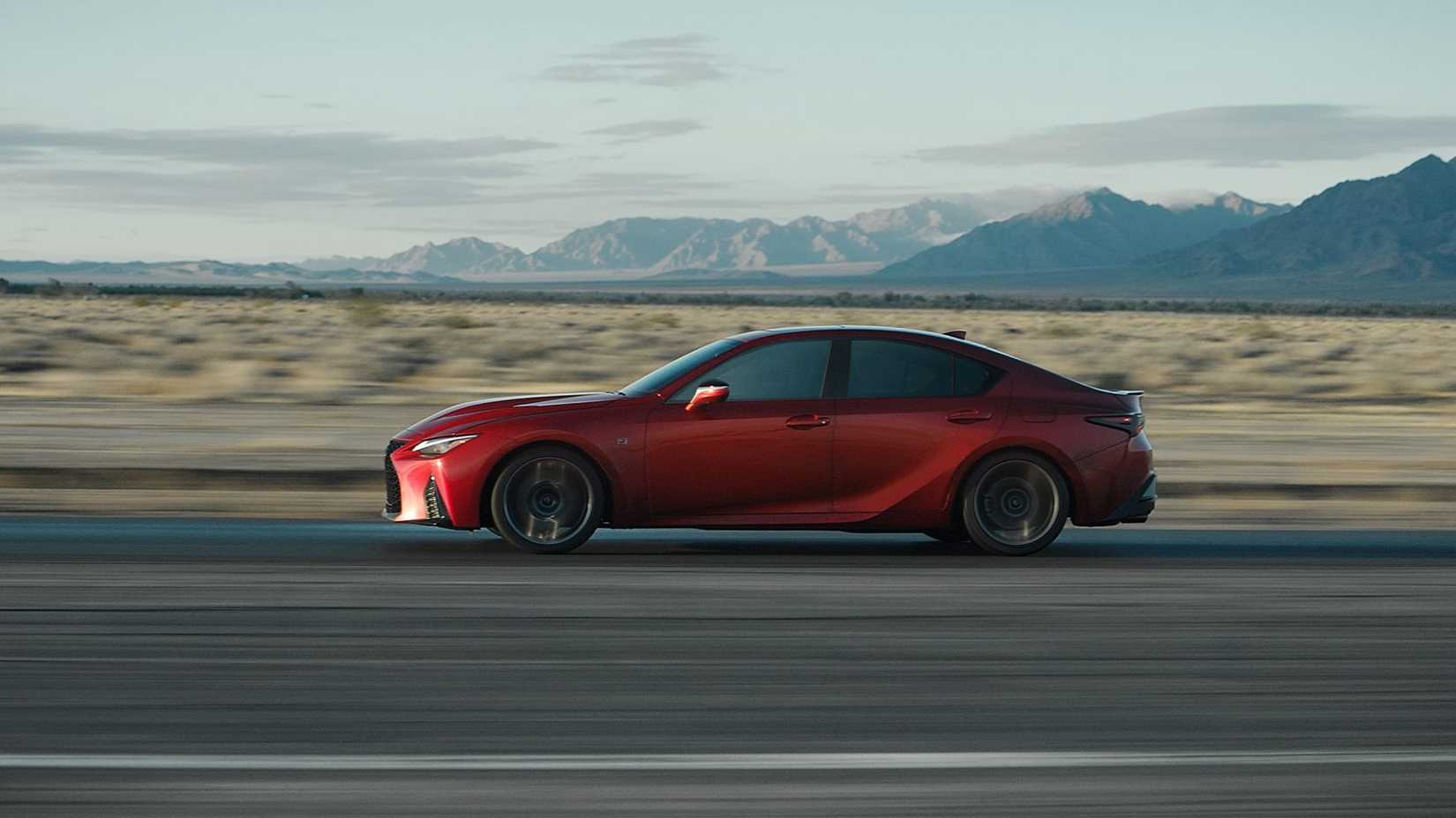 Side-shot 2024 Lexus IS500 F Sport driving on road