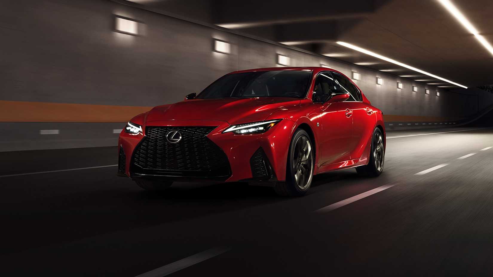 Red 2024 Lexus IS500 F Sport front shot driving through the tunnel