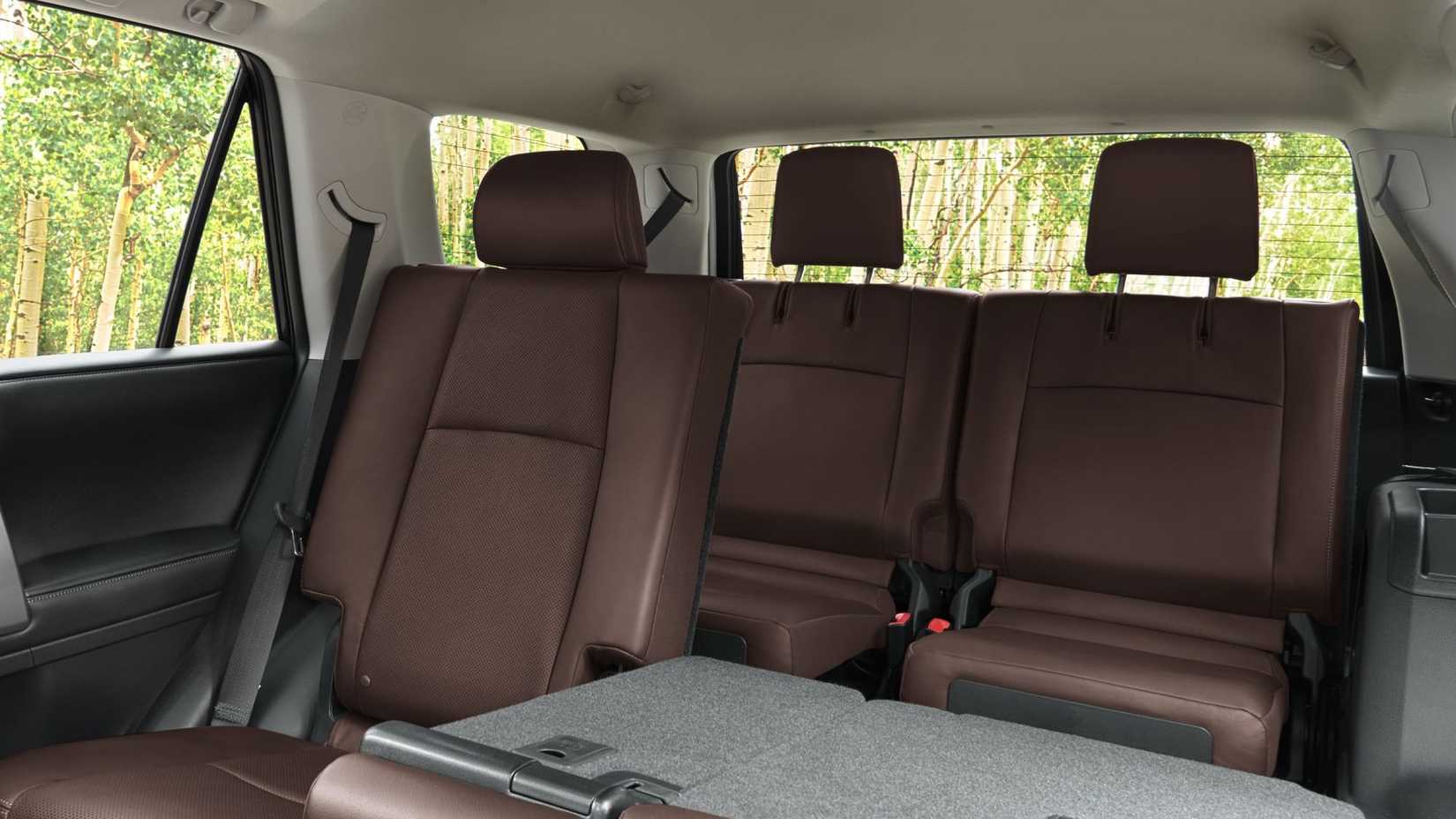 Brown interior of the 2024 Toyota 4Runner with second row seats folded down and third row folded up.