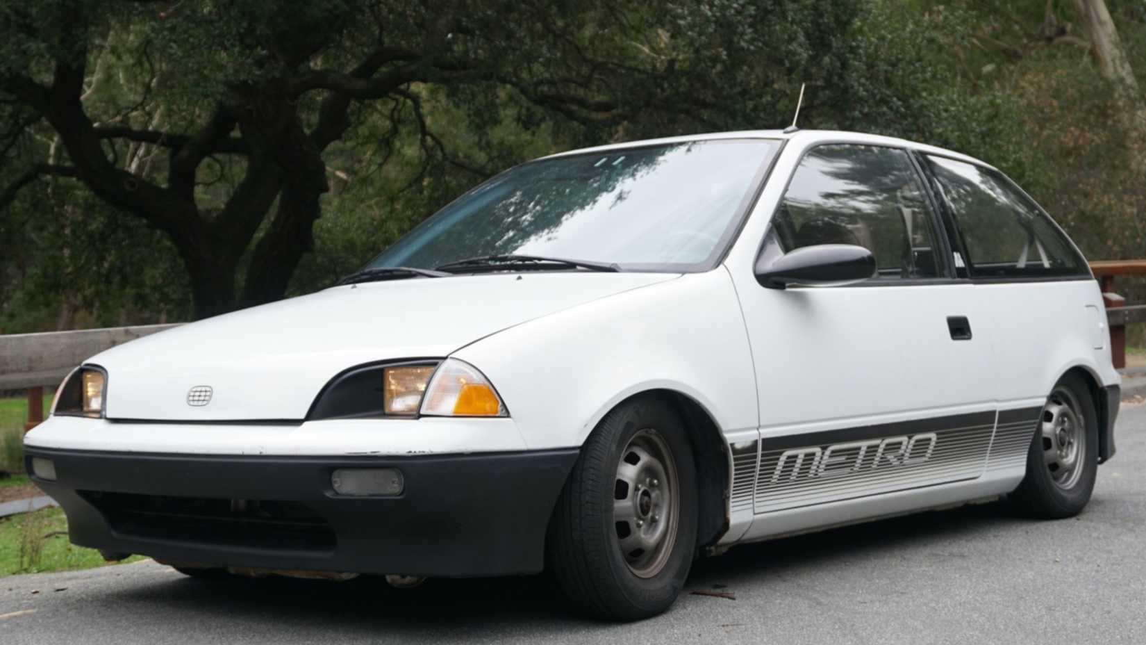 1990 Geo Metro Hatchback in white posing on road