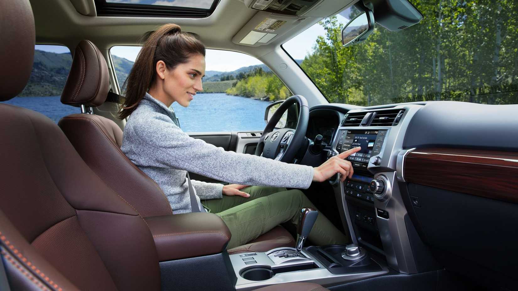 2024 Toyota 4Runner with person using infotainment