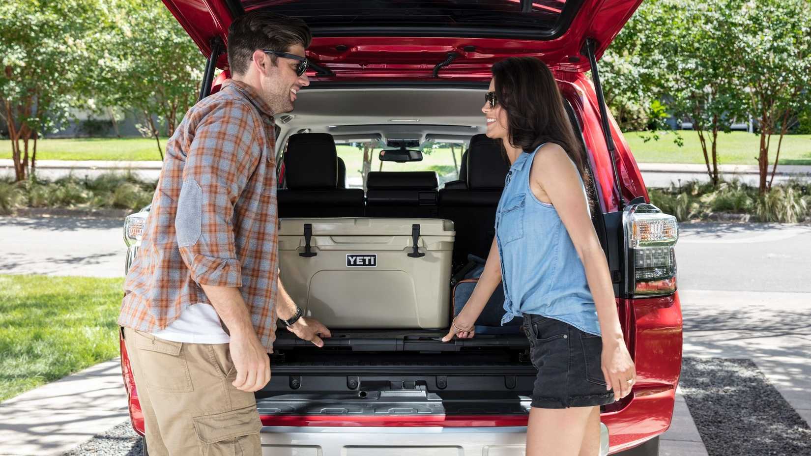 2024 Toyota 4Runner with hatch open and people putting cooler in back
