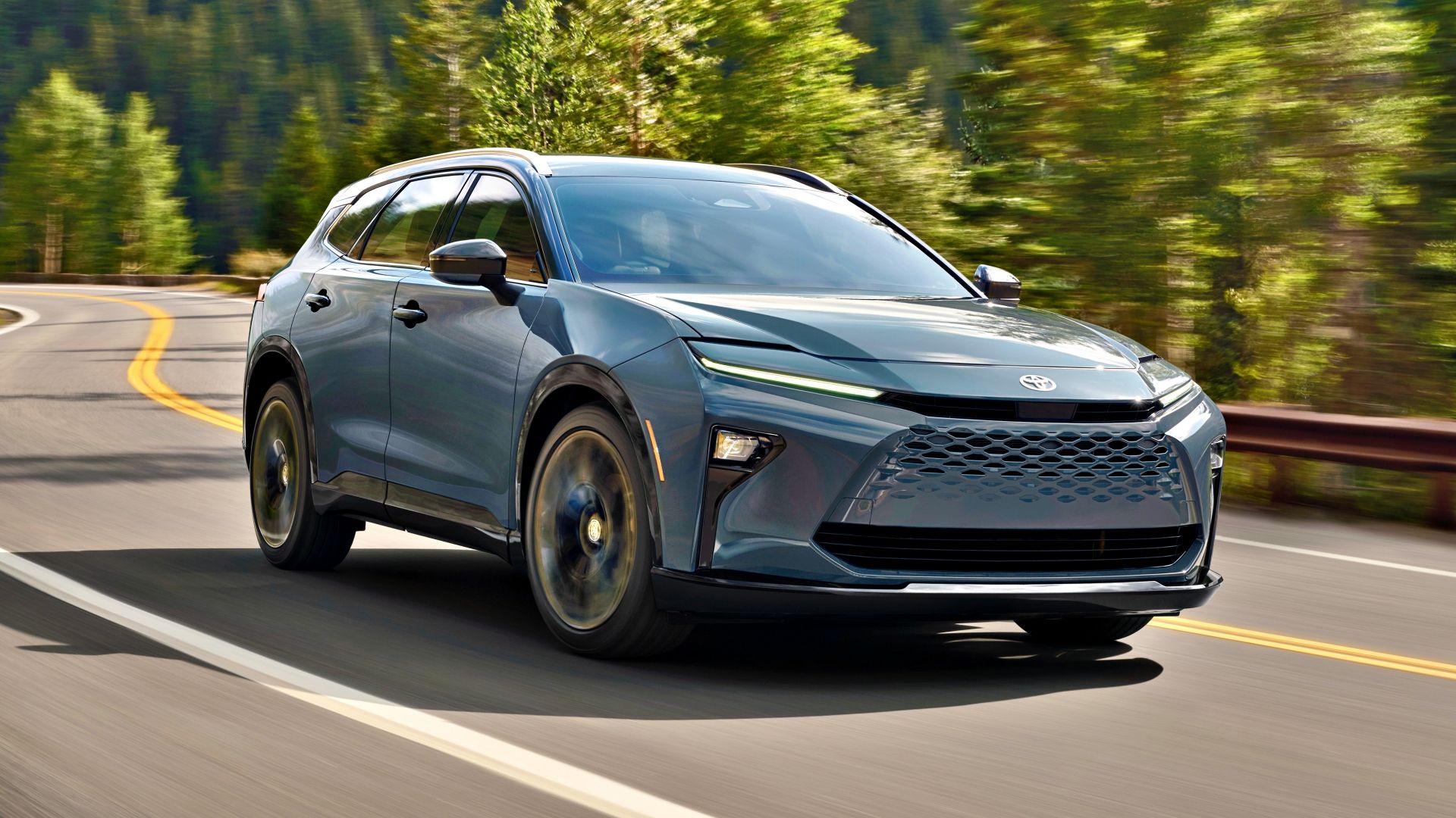 A front 3/4 action shot of a blue 2025 Toyota Crown Signia SUV