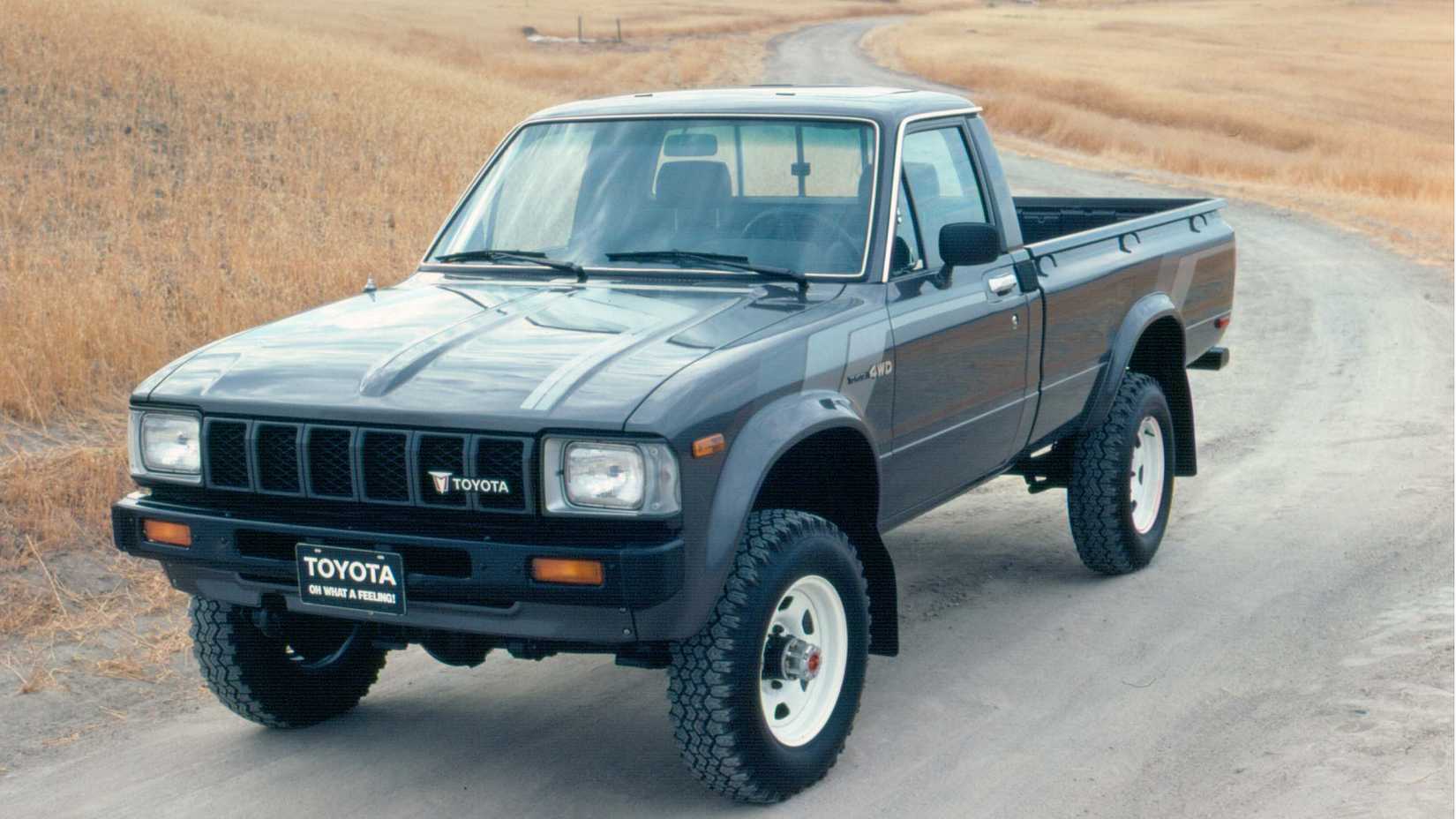 1984 Toyota Hilux Pickup truck parked on a dirt road in an open field