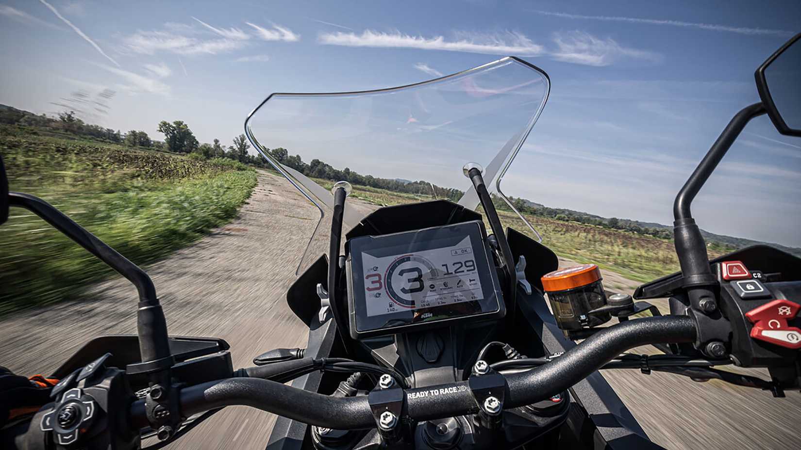 Action shot of a 2023 KTM 1290 SUPER ADVENTURE  from rider-view perspective showing TFT screen.