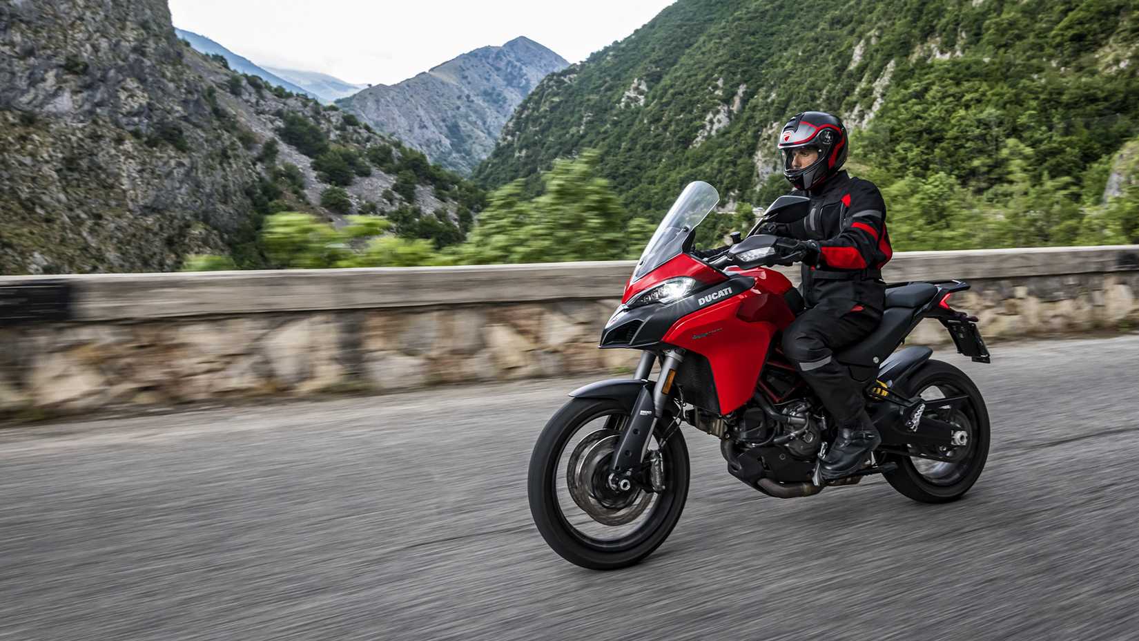 Side left action shot of a red 2021 Ducati Multistrada 950