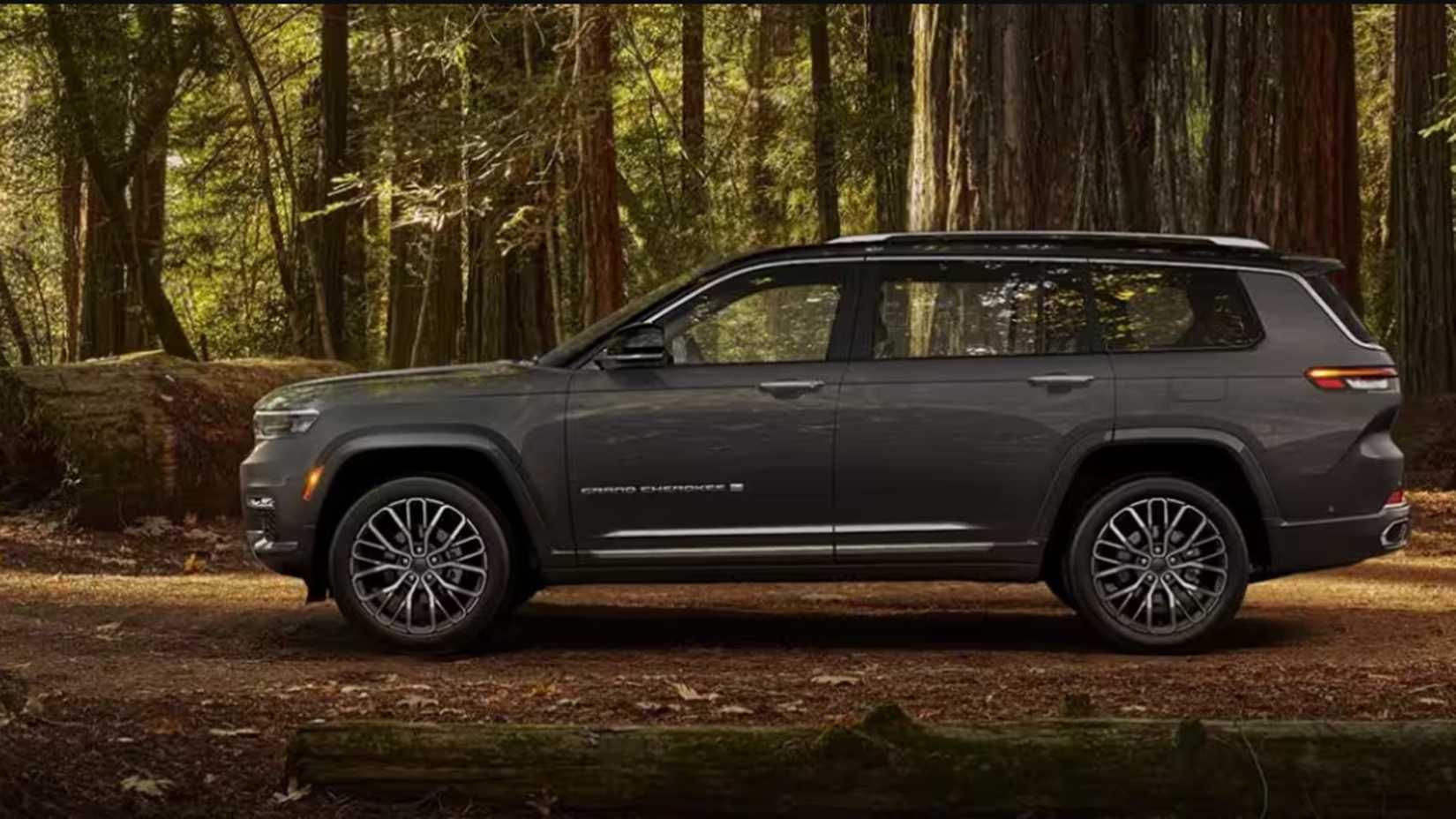 A Jeep Grand Cherokee L in gray parked in a wooded area