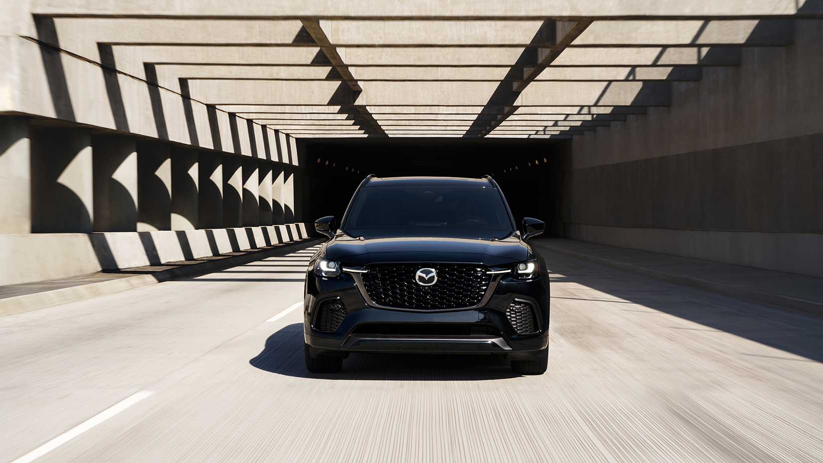Front shot of a 2025 Mazda CX-70 driving on the road