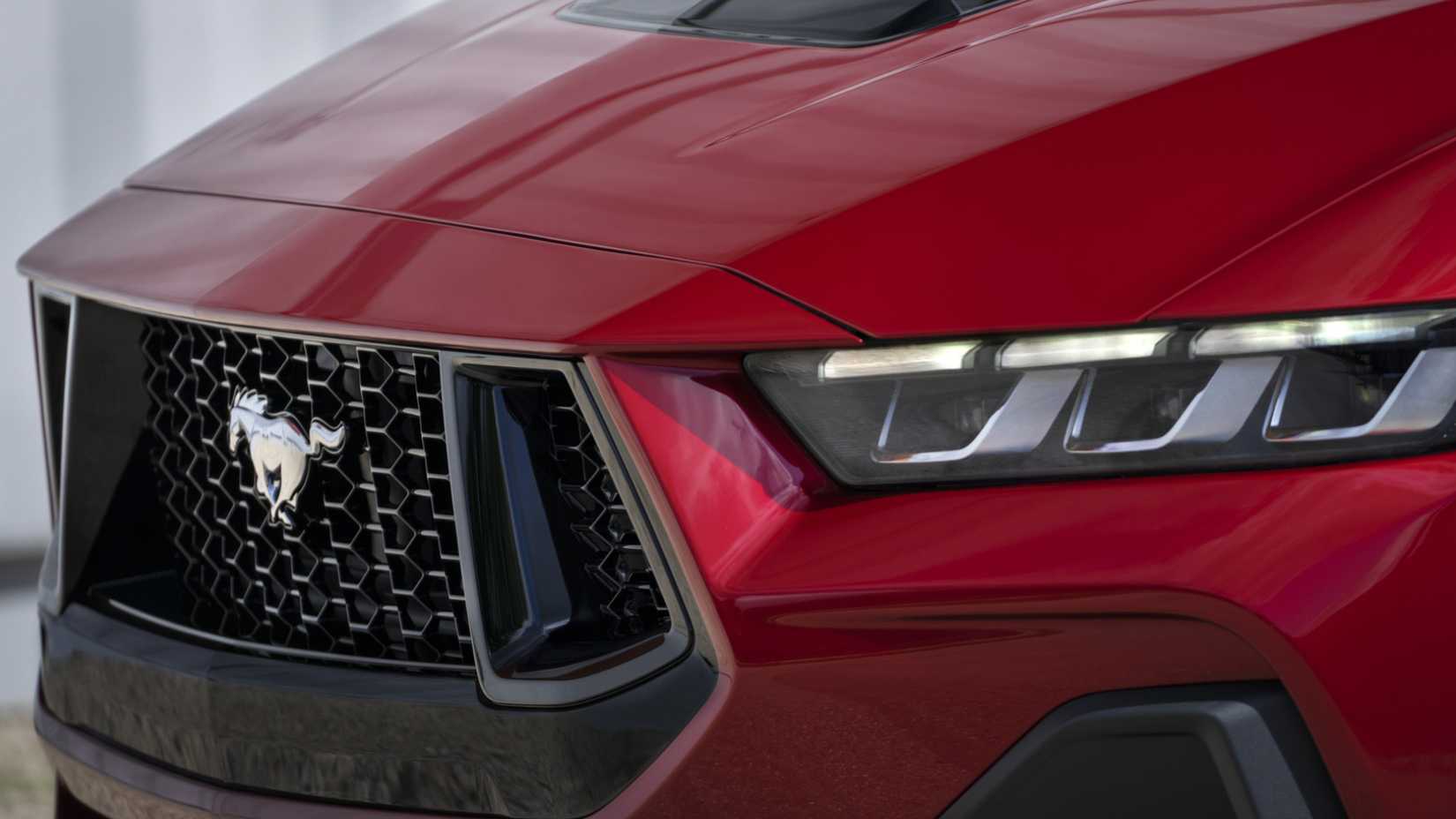 2024 Ford Mustang S650 front end in red showing grille, headlights, and badge