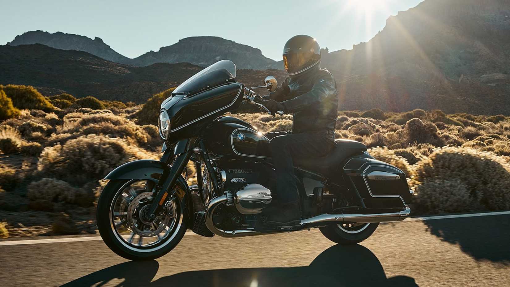 BMW R 18 B cruiser motorcycle riding down the highway. 