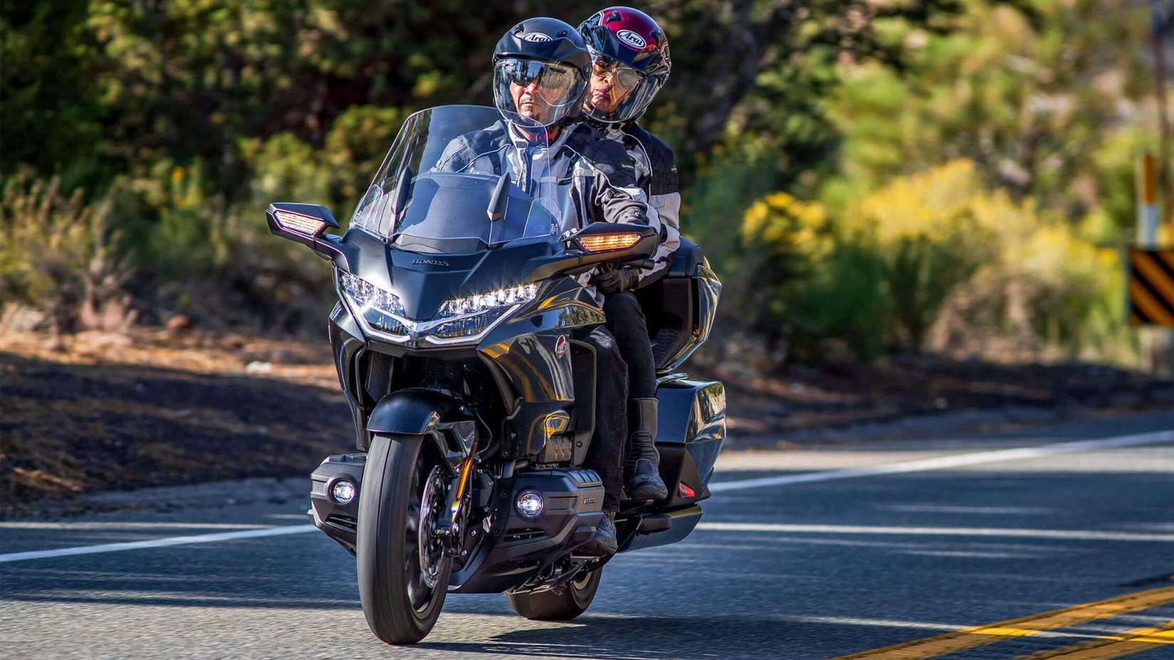 2024 Honda Gold Wing Tour front shot with pillion riding on road