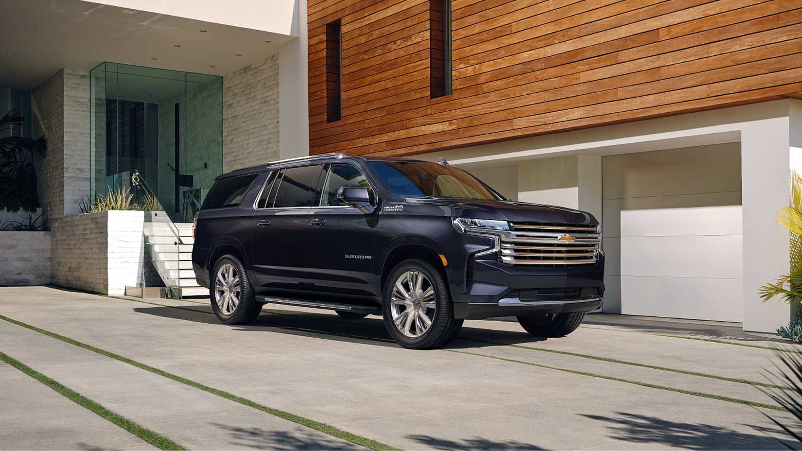 2025 Chevrolet Suburban parked outside a residential garage