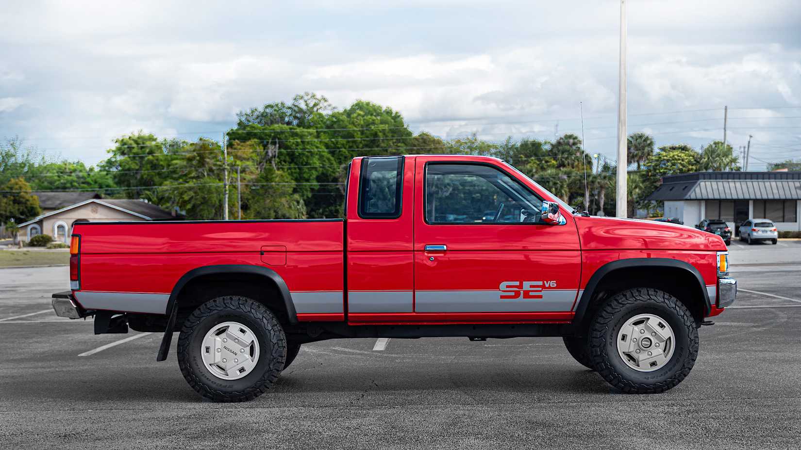 1993 Nissan Hardbody King Cab SE V6 in red Posing in parking lot