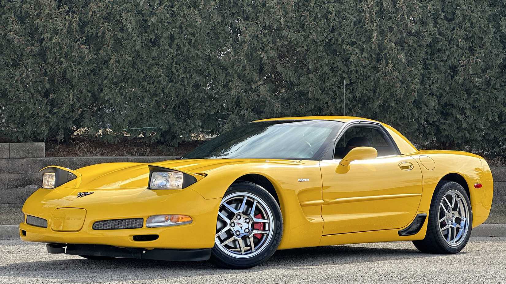Side 3/4 shot of 2001 Chevrolet Corvette Z06 In yellow Posing on driveway