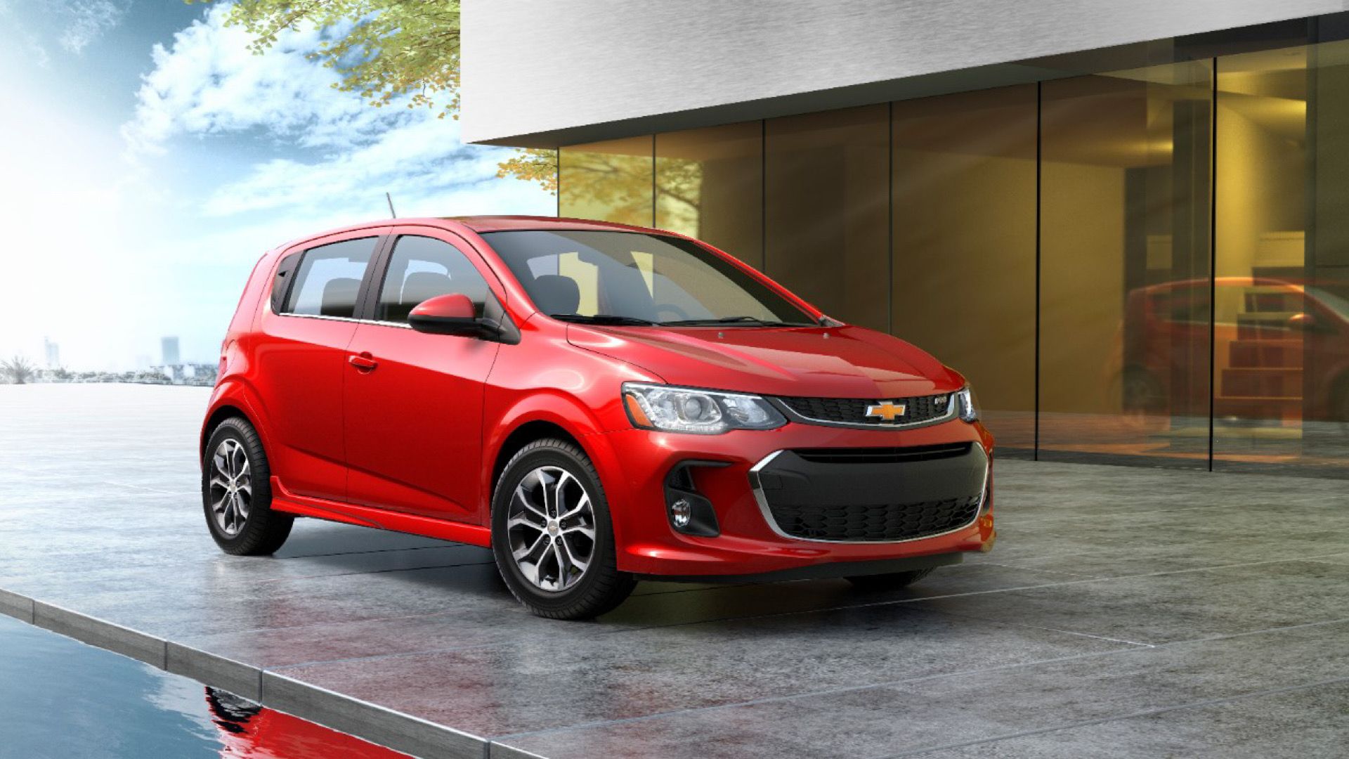 2020 Chevrolet Sonic In red Posing against office building
