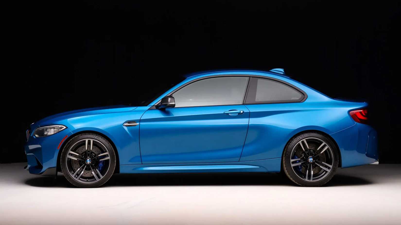 A Blue 2016 BMW M2 side shot parked in studio