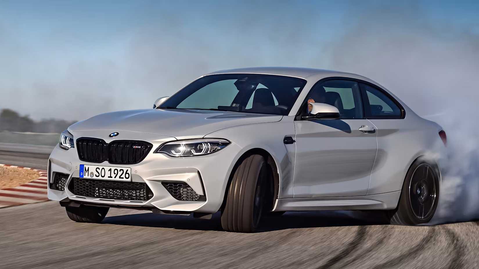 A Silver 2018 BMW M2 Competition front 3/4 action shot drifting