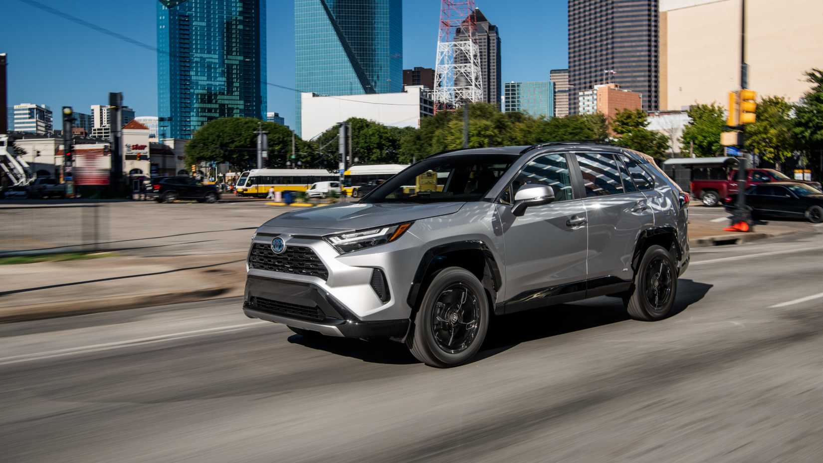 Silver 2022 Toyota RAV4 SE Hybrid cruising on a highway.