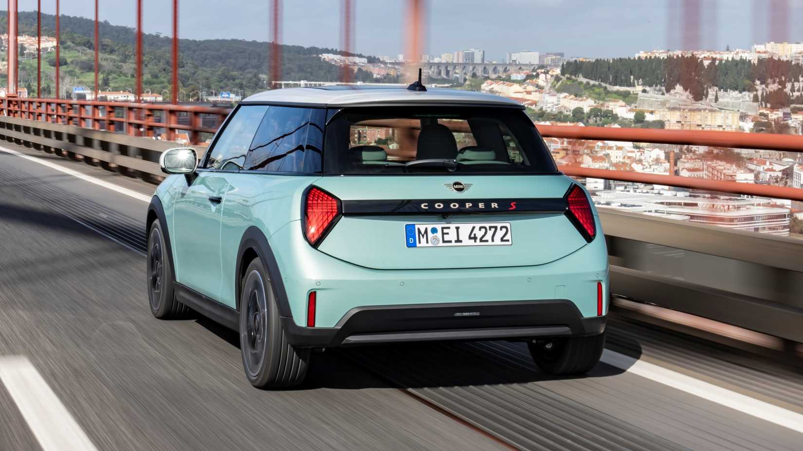 2024 Mini Cooper S rear 3/4 action shot driving on a bridge. 