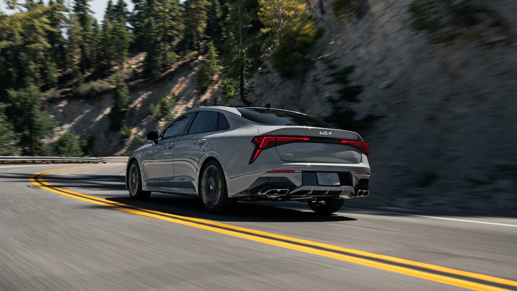 Rear 3/4 action shot of the 2025 Kia K5