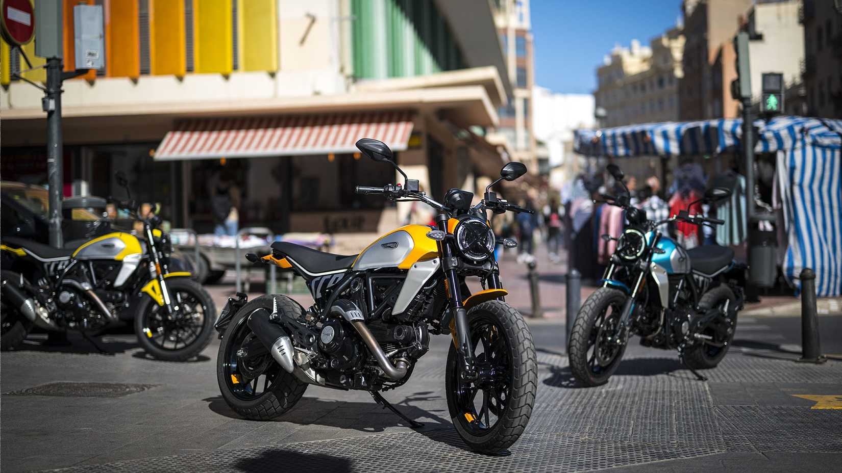 Outdoor shot of three Ducati Scrambler icons