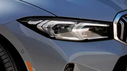 Foto externa do BMW 330i Sedan 2024 mostrando farol dianteiro de LED e pneu