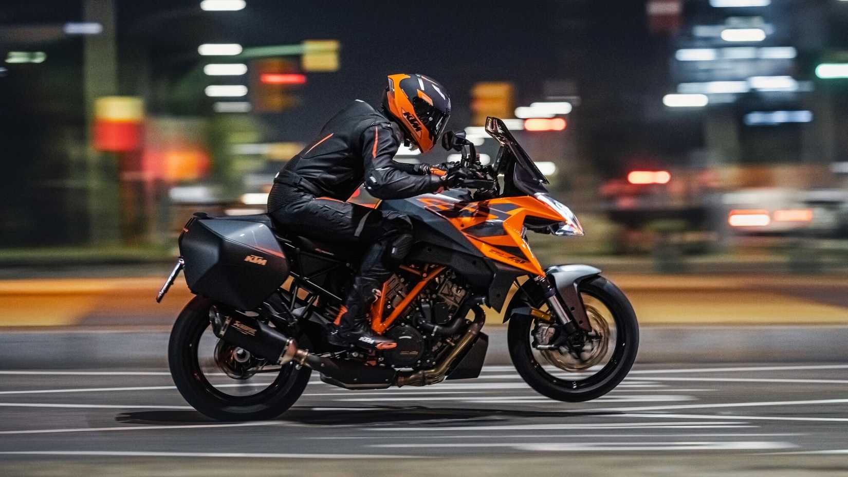 KTM 1290 Super Duke GT popping a wheelie side profile view