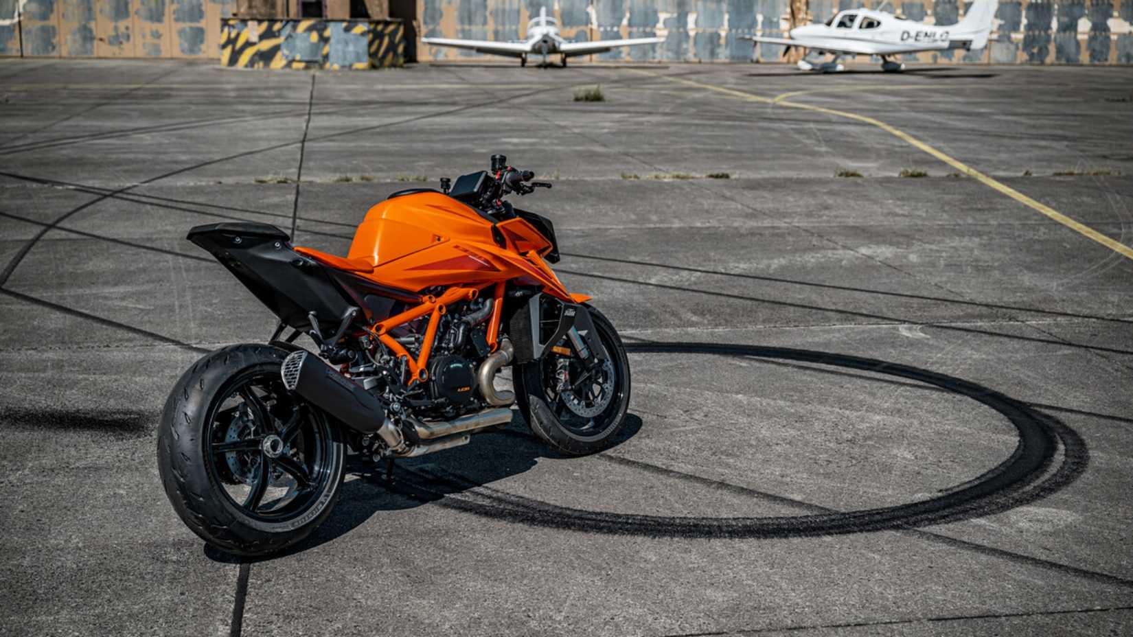 Rear view of KTM 1390 Super Duke R Evo parked on an airstrip