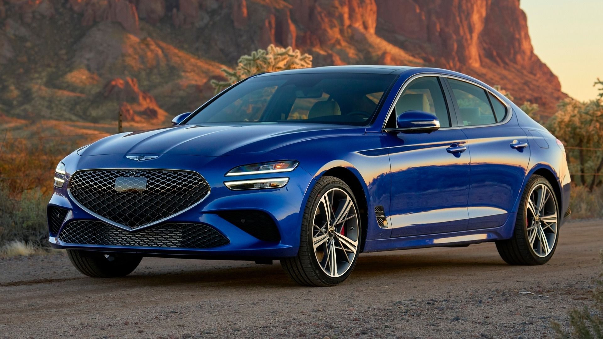 Blue 2024 Genesis G70 Sedan Parked In The Desert Front 3/4 View
