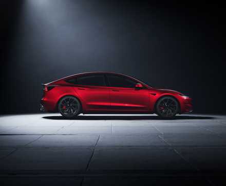 Foto de perfil lateral de um Tesla Model 3 Performance 2024 vermelho