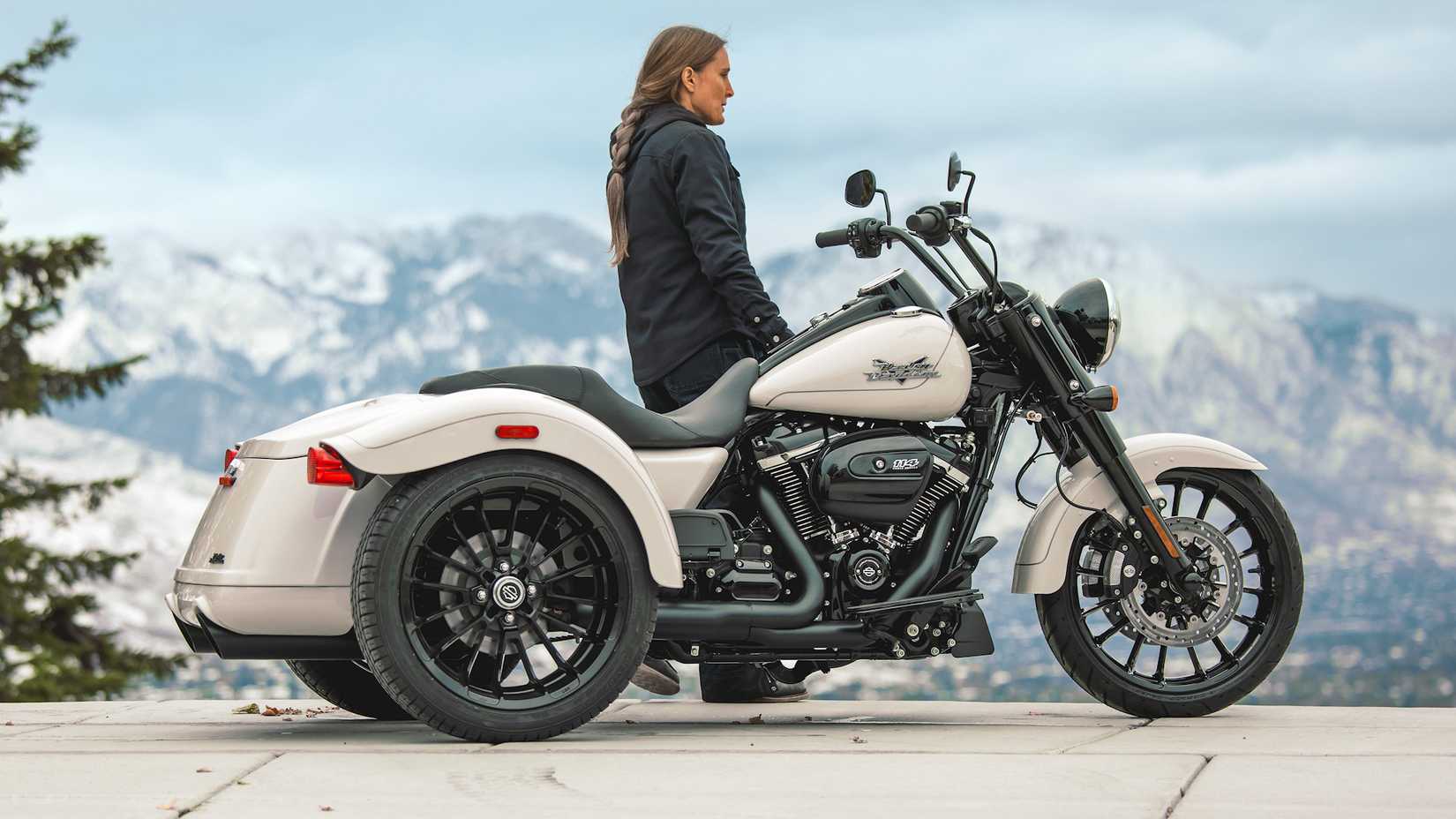 Rider standing next to a 2023 Harley-Davidson Freewheeler