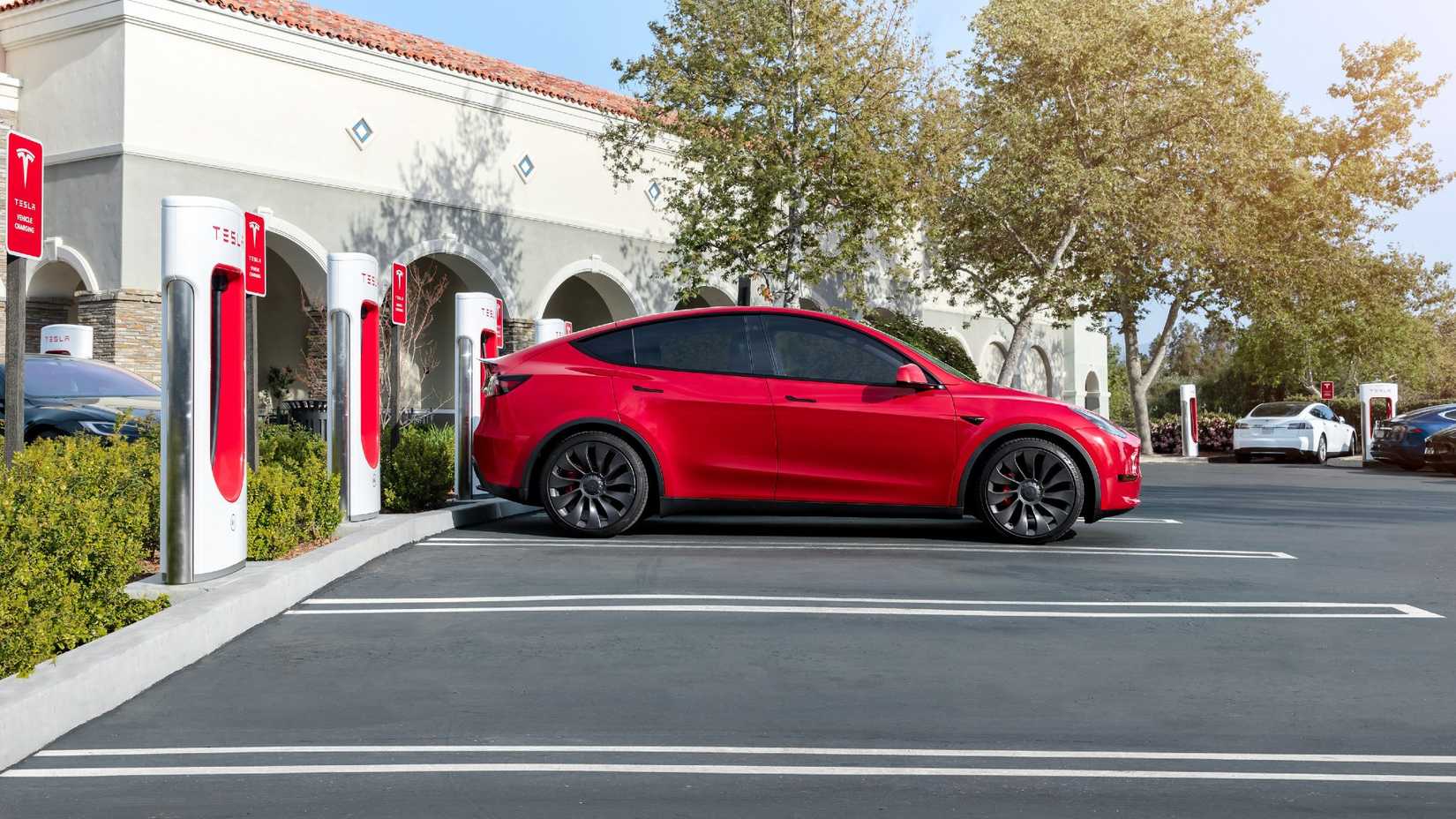 Tesla modelo Y vermelho carregando em um supercharger Tesla