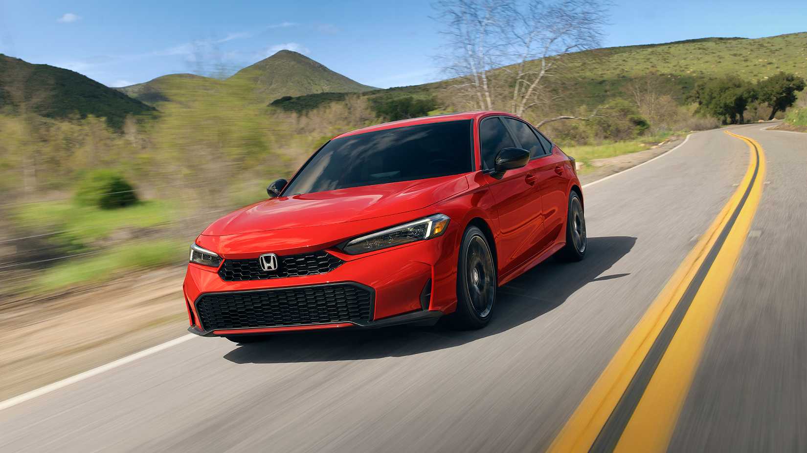 Front 3/4 shot of a 2025 Honda Civic Sedan LX driving down highway