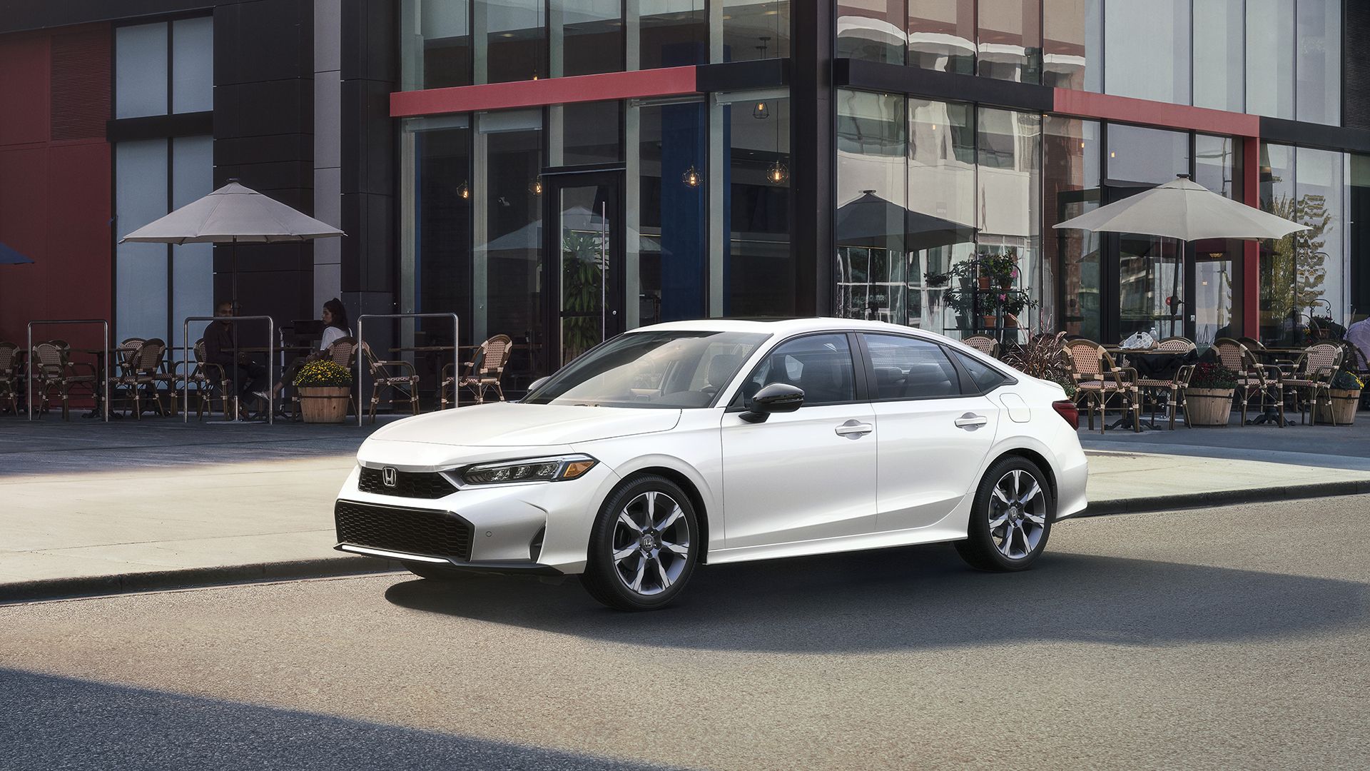 Front three-quarters shot of a white 2025 Honda Civic Sedan Sport Touring Hybrid