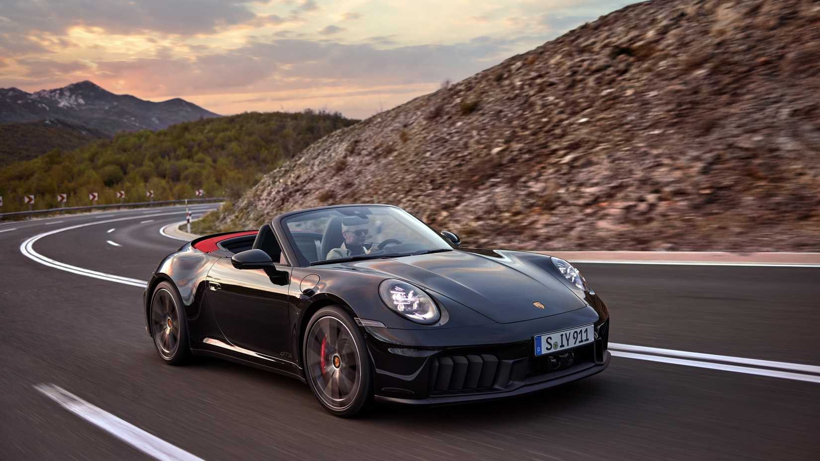 Three-quarter photo from the front of a black 2025 Porsche 911 Cabriolet 