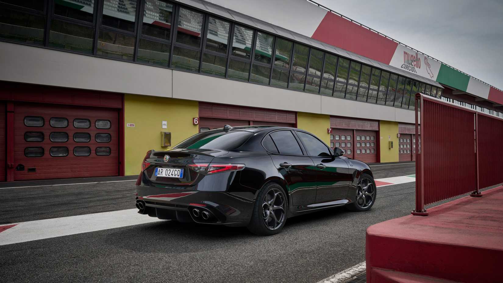 Foto traseira 3/4 de um Alfa Romeo Giulia Super Sport 2024 estacionado em frente à garagem
