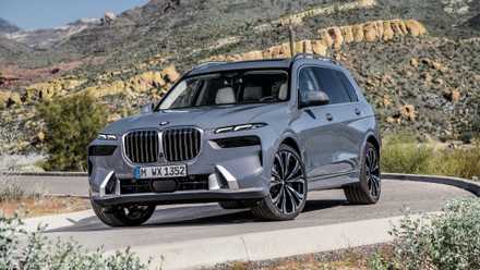2024 BMW X7 in gray driving on country road