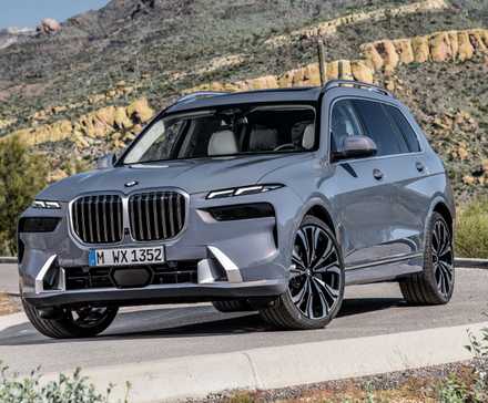 2024 BMW X7 in gray driving on country road