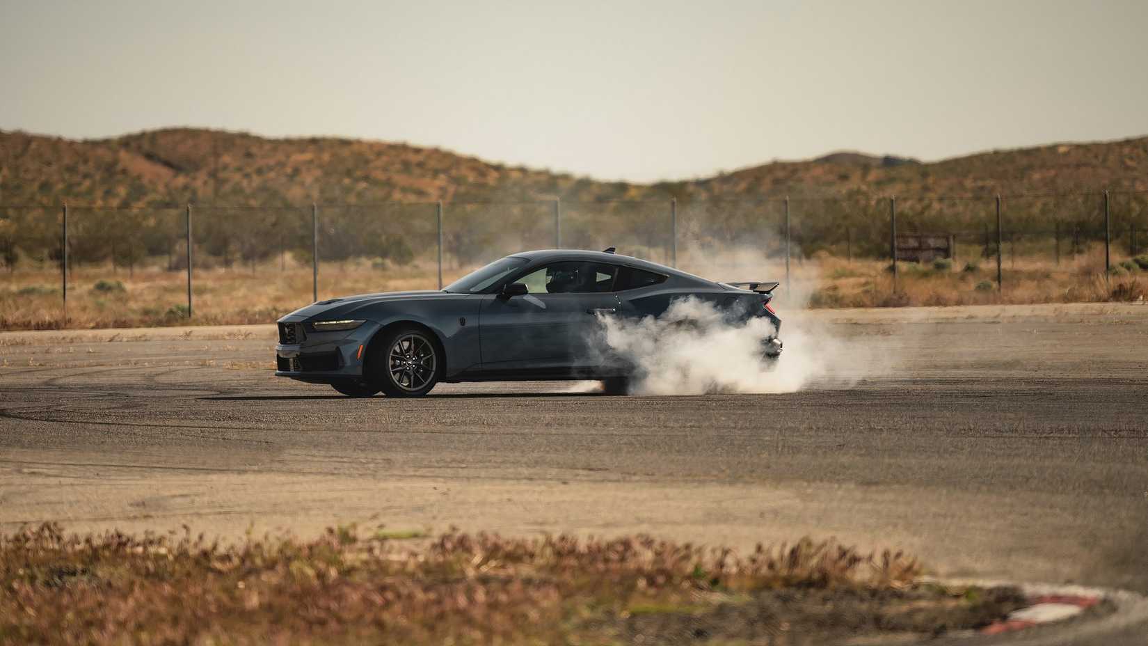 2024 Ford Mustang EcoBoost side left doing a burnout