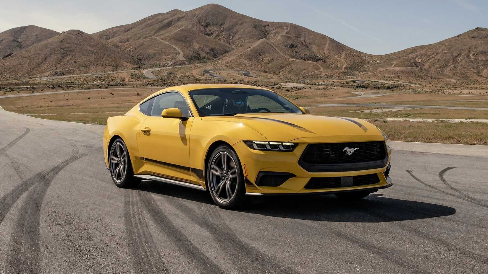Yellow 2024 Ford Mustang EcoBoost With Black Stripes Parked Front 3/4 View