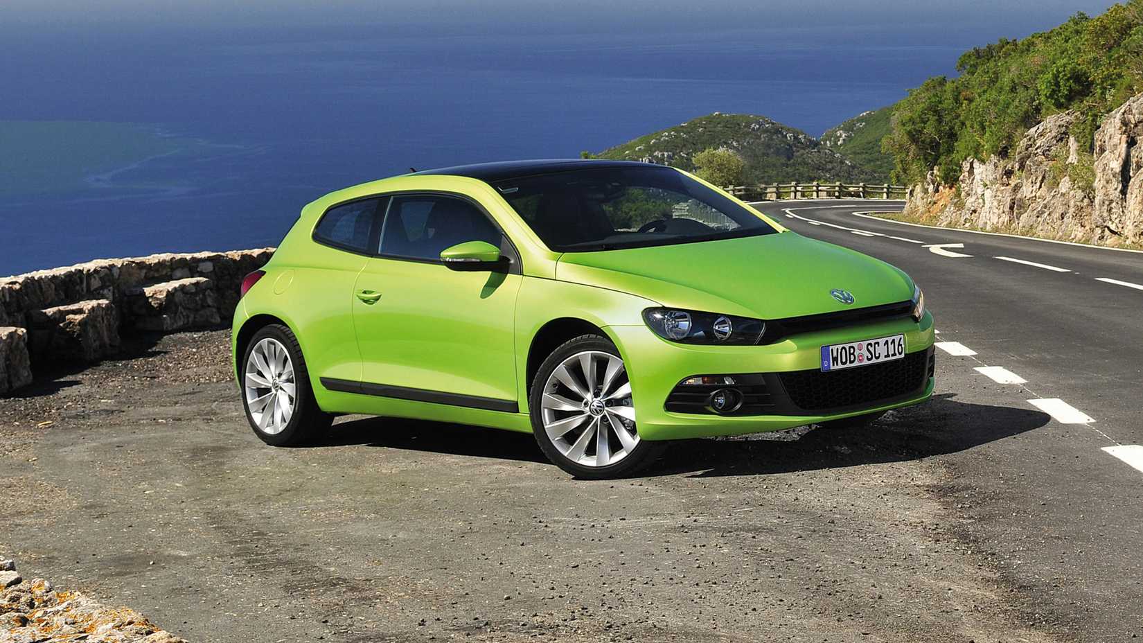 Green Volkswagen Scirocco Parked By Mountain Pass Front 3/4 View