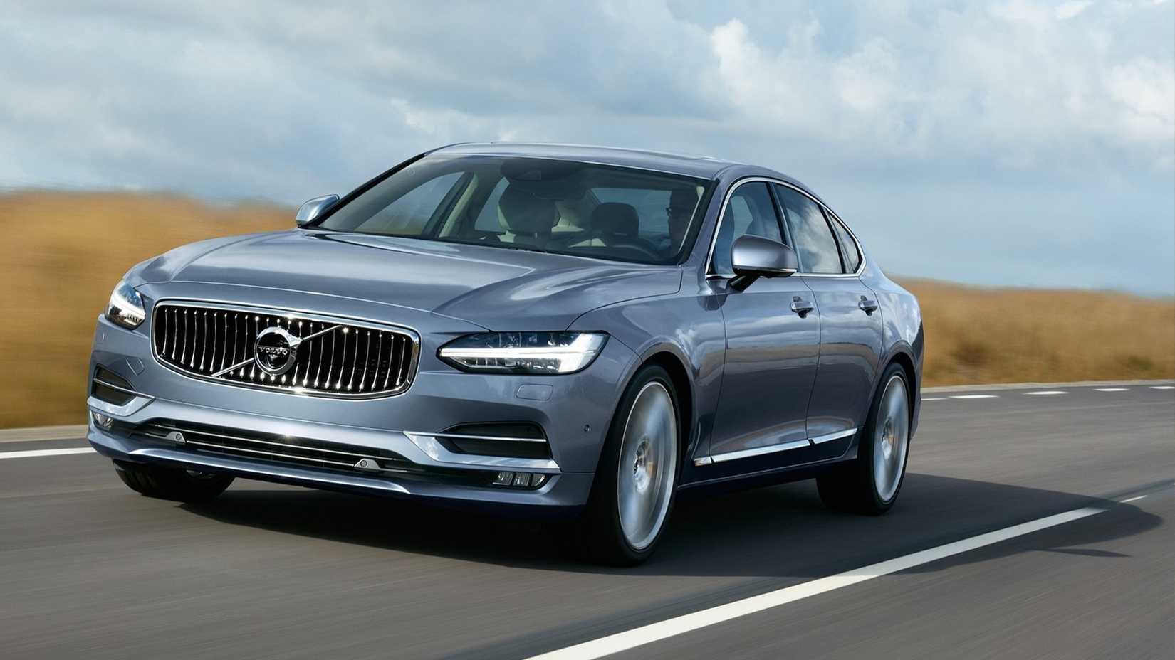 Front 3/4 view of 2018 grey Volvo S90 driving on the road