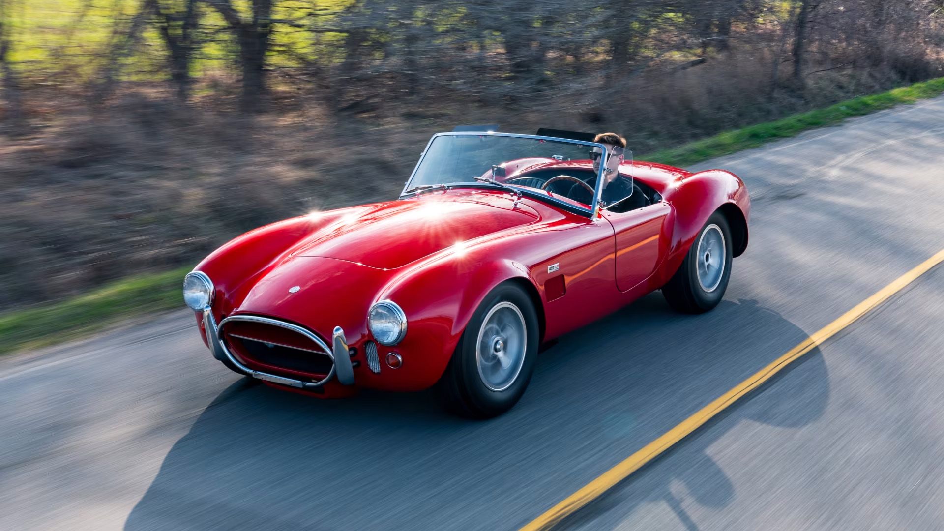 A Red 1966 AC Shelby Cobra 427 Driving