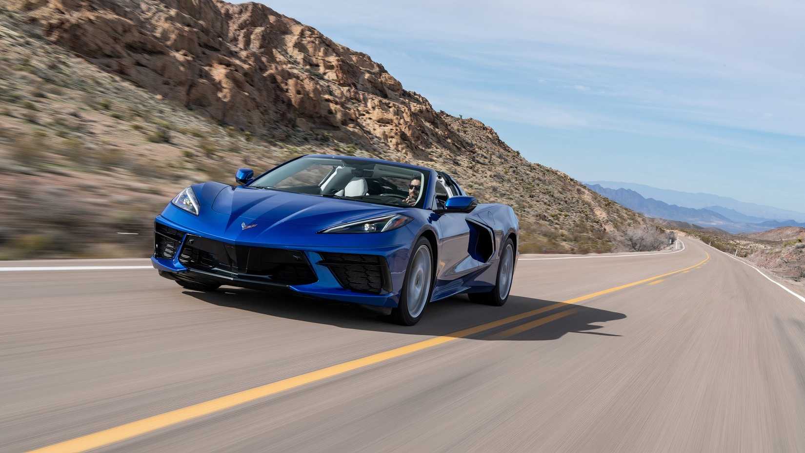 2020 Chevrolet Corvette Stingray navy blue driving on a two lane highway