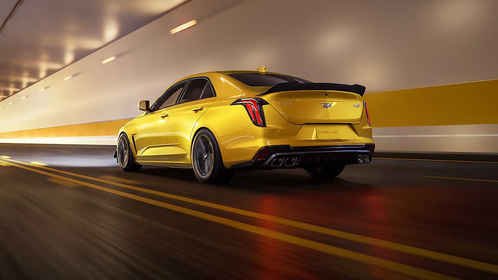 Rear 3/4 shot of a yellow 2024 Cadillac CT4-V Blackwing driving